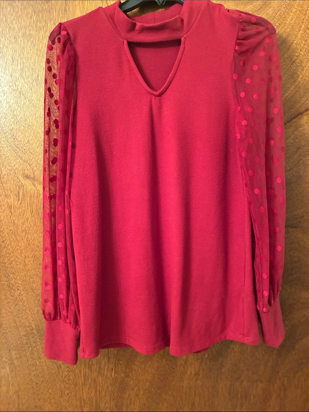 Wine colored shirt with polka dotted sheer sleeves size medium